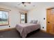 Cozy bedroom with a full-size bed and large windows at 2550 Daybreak Trl, Burlington, NC 27215