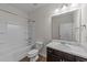 Clean bathroom featuring a shower-tub combo, and dark vanity with a marble countertop at 256 Barbour Farm Ln, Four Oaks, NC 27524