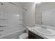 Bathroom featuring a shower-tub combo, and dark vanity with a marble countertop at 256 Barbour Farm Ln, Four Oaks, NC 27524