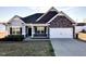 Charming single-Gathering home with a manicured lawn and attached two-car garage at 256 Barbour Farm Ln, Four Oaks, NC 27524