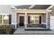 Dark brown front door with stone accents and a welcoming porch at 256 Barbour Farm Ln, Four Oaks, NC 27524