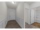 Bright hallway with wood floors, wainscoting, and access to a bathroom at 256 Barbour Farm Ln, Four Oaks, NC 27524