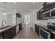 Spacious kitchen with stainless steel appliances, granite countertops, and an open view to the dining room at 256 Barbour Farm Ln, Four Oaks, NC 27524