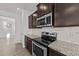Close up of a modern kitchen with stainless steel oven, microwave, and granite countertops at 256 Barbour Farm Ln, Four Oaks, NC 27524