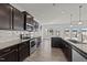 Modern kitchen with dark cabinets, stainless steel appliances, granite countertops, and hardwood floors at 256 Barbour Farm Ln, Four Oaks, NC 27524