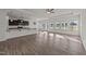 Open-concept living area flows seamlessly into a modern kitchen with abundant natural light and hardwood floors at 256 Barbour Farm Ln, Four Oaks, NC 27524