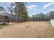 Expansive backyard featuring mature trees, a fenced perimeter, and a screened-in porch, perfect for outdoor enjoyment at 296 Wilson Farm Ln, Clayton, NC 27527