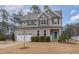 Two-story home featuring a manicured lawn, a two car garage, and an inviting entrance at 296 Wilson Farm Ln, Clayton, NC 27527