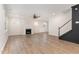 Spacious living room with wood floors, a fireplace, and a staircase to the second floor at 296 Wilson Farm Ln, Clayton, NC 27527