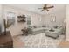 Inviting living room featuring a spacious sectional sofa, ceiling fan, and stylish decor on floating shelves at 296 Wilson Farm Ln, Clayton, NC 27527