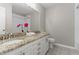 Bathroom with granite countertop, double sinks, and white cabinets at 307 Colony Woods Dr, Chapel Hill, NC 27517