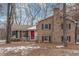 Brick ranch house with red door, shutters, and landscaping; snowy yard at 307 Colony Woods Dr, Chapel Hill, NC 27517