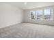 Bright bedroom with carpeted floor and three windows at 310 Church St # 35, Wendell, NC 27591