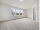 Spacious bedroom with carpeted floor and three windows at 310 Church St # 35, Wendell, NC 27591
