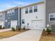 Two-car garage with white doors and landscaping at 310 Church St # 35, Wendell, NC 27591