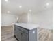 Open concept kitchen with gray island and white cabinets at 310 Church St # 35, Wendell, NC 27591