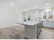 Open concept kitchen with gray island and white cabinets at 310 Church St # 35, Wendell, NC 27591