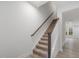Carpeted staircase with wooden railing and view of entry at 310 Church St # 35, Wendell, NC 27591