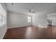 Open living room with hardwood floors and view into kitchen at 4104 Ludgate Dr, Durham, NC 27713