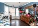 Bedroom with twin bed, dresser, and bay window at 4209 Medlar Ln, Raleigh, NC 27616