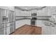 Modern kitchen with white cabinets, granite countertops, and stainless steel appliances at 4294 Sustain Cir, Franklinton, NC 27525