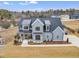 Two-story home, gray exterior, metal roof, and large windows at 44 Maeview Ln, Raleigh, NC 27603