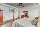 Main bedroom with a post bed, hardwood floors, and a large TV at 44 Maeview Ln, Raleigh, NC 27603