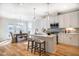 Modern kitchen with white cabinets, island, and stainless steel appliances at 4615 Apple Ridge Ln, Graham, NC 27253