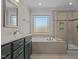Elegant bathroom with double vanity, soaking tub, and walk-in shower at 467 Joseph Alexander Dr, Fuquay Varina, NC 27526