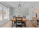 Elegant dining room with a modern chandelier, large window, and seating for six at 467 Joseph Alexander Dr, Fuquay Varina, NC 27526