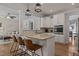 Well-equipped kitchen with granite countertops, white cabinetry, an island, and modern pendant lighting at 467 Joseph Alexander Dr, Fuquay Varina, NC 27526