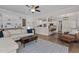 Open-concept living room with hardwood floors, comfortable seating, and an adjacent modern kitchen at 467 Joseph Alexander Dr, Fuquay Varina, NC 27526