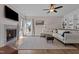 Comfortable living room with a stone fireplace, hardwood floors, ceiling fan and lots of natural light at 467 Joseph Alexander Dr, Fuquay Varina, NC 27526