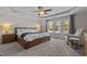 Spacious main bedroom with wood platform bed, ceiling fan, and tranquil backyard view at 467 Joseph Alexander Dr, Fuquay Varina, NC 27526