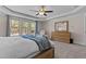 Relaxing main bedroom featuring a king-size bed, ceiling fan, and large windows at 467 Joseph Alexander Dr, Fuquay Varina, NC 27526