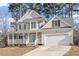 Two story house with a wrap around porch and two car garage at 5 Spring Water Ln, Durham, NC 27712