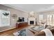 Bright living room features hardwood floors, a fireplace, and ample natural light at 5 Spring Water Ln, Durham, NC 27712