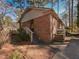 Back of house with brick and steps leading to patio at 5200 Newhall Rd, Durham, NC 27713