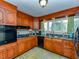 Bright kitchen with wood cabinets, modern appliances, and tile floor at 5200 Newhall Rd, Durham, NC 27713