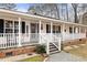 Spacious front porch with rocking chairs and white railings at 59 Irene Ct, Fuquay Varina, NC 27526