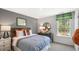 Guest bedroom with window, and grey and orange decor at 6461 Alfalfa Ln, Wake Forest, NC 27587