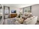 Bright living room with comfy sofas, large windows, and hardwood floors at 6461 Alfalfa Ln, Wake Forest, NC 27587