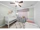 bedroom with crib, twin bed, and dresser at 6617 Portsmouth Ln, Raleigh, NC 27615