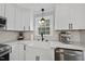 Modern farmhouse kitchen features a white farm sink and quartz countertops at 6617 Portsmouth Ln, Raleigh, NC 27615