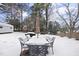 Snow-covered patio with dining set and umbrella at 6617 Portsmouth Ln, Raleigh, NC 27615