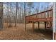 This backyard features a wooden deck and mature trees at 6645 Austin Creek Dr, Wake Forest, NC 27587