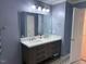 Modern bathroom with double vanity, marble countertop, and large mirror at 6645 Austin Creek Dr, Wake Forest, NC 27587