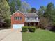 Charming two-story home with a brick facade, attached garage, and a well-manicured front yard at 6645 Austin Creek Dr, Wake Forest, NC 27587