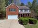 Charming two-story home with a brick facade, attached garage, and a well-manicured front yard at 6645 Austin Creek Dr, Wake Forest, NC 27587