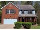Charming two-story home with a brick facade, attached garage, and a well-manicured front yard at 6645 Austin Creek Dr, Wake Forest, NC 27587